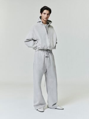 Detailed views and lifestyle shots of the authentic Essentials classic hoodie featuring a premium beveled metallic logo, managed by Zizzle LLC.