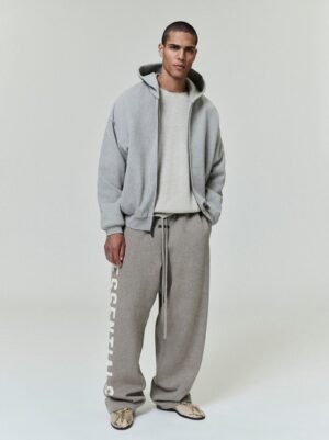 Full lifestyle views of a model wearing the authentic Grey Essentials soft-touch logo hoodie and matching sweatpants, curated by Zizzle LLC.