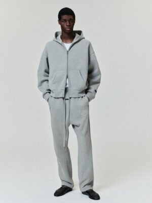 Full lifestyle shots of a model wearing the authentic 380gsm Grey Essentials classic full-zip hoodie and matching joggers, managed by Zizzle LLC.